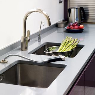 kitchen room with sink tap and vegetables