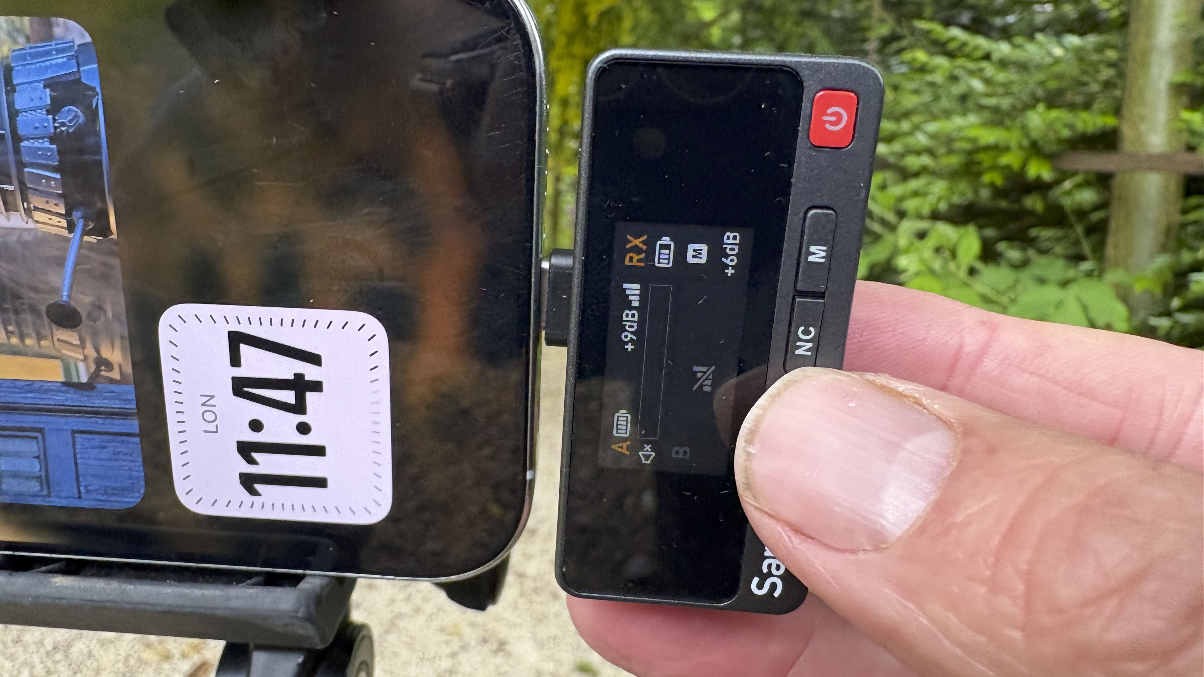 Close-up of receiver which displays the strength of incoming sound levels. It is plugged via USB-C adaptor into an iPhone 16 Pro