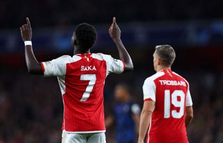 Bukayo Saka of Arsenal celebrates scoring their teams second goal with Leandro Tossard of Arsenal during the UEFA Champions League match between Arsenal FC and Sevilla FC at Emirates Stadium on November 08, 2023 in London, England.
