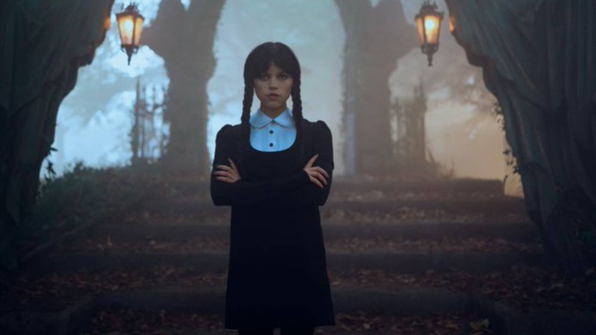 Jenna Ortega as Wednesday Addams standing in a graveyard during season 1 of the Netflix series, Wednesday. 