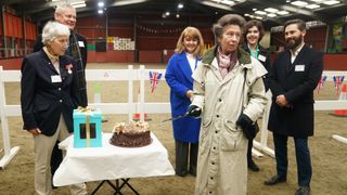 Princess Anne, The Princess Royal and Vice Patron of the British Horse Society cuts a cake during a visit to Wormwood Scrubs Pony Centre on February 8, 2024