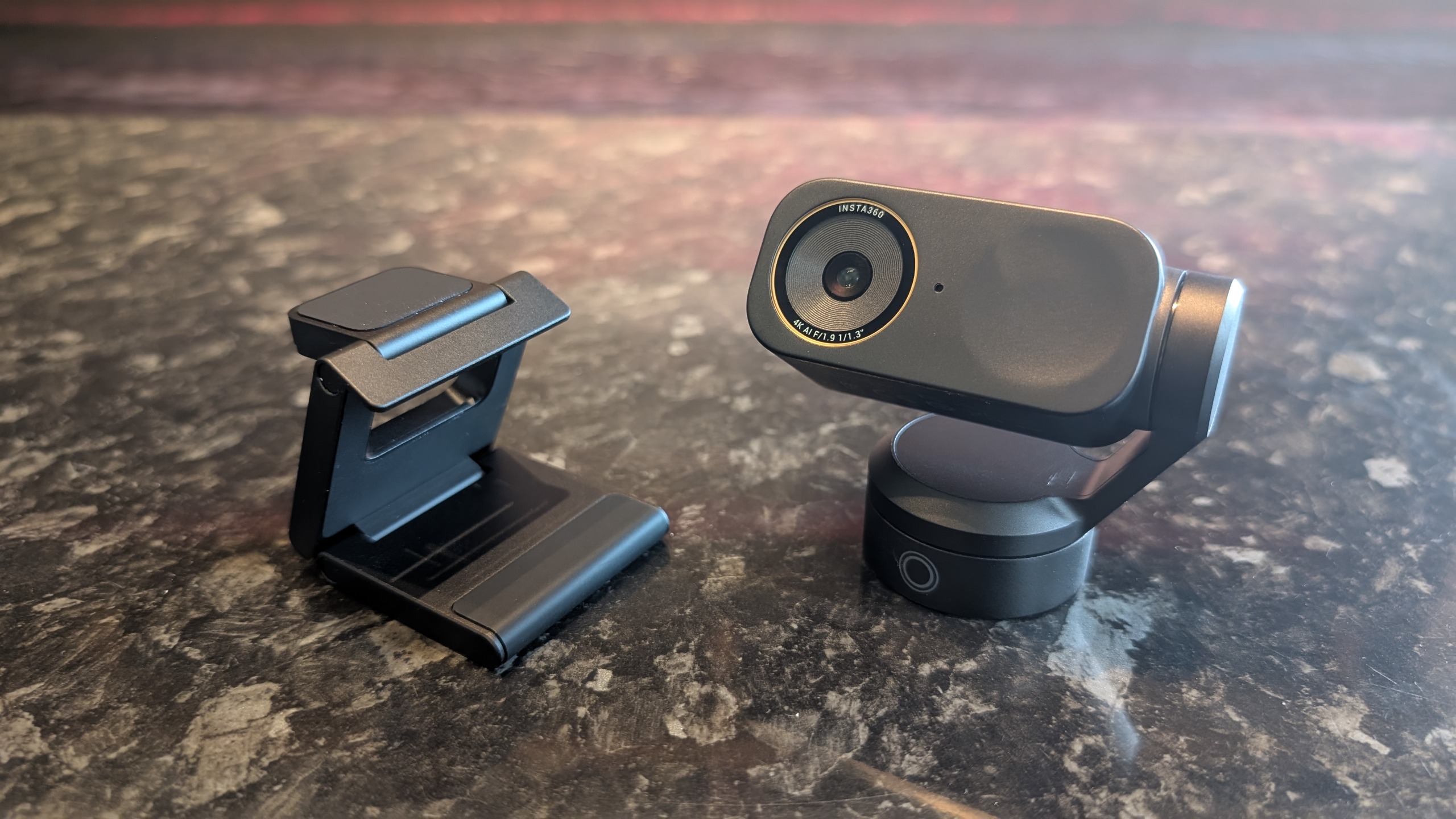 The Insta360 Link 2 Pro webcam, pictured on a marble worktop.