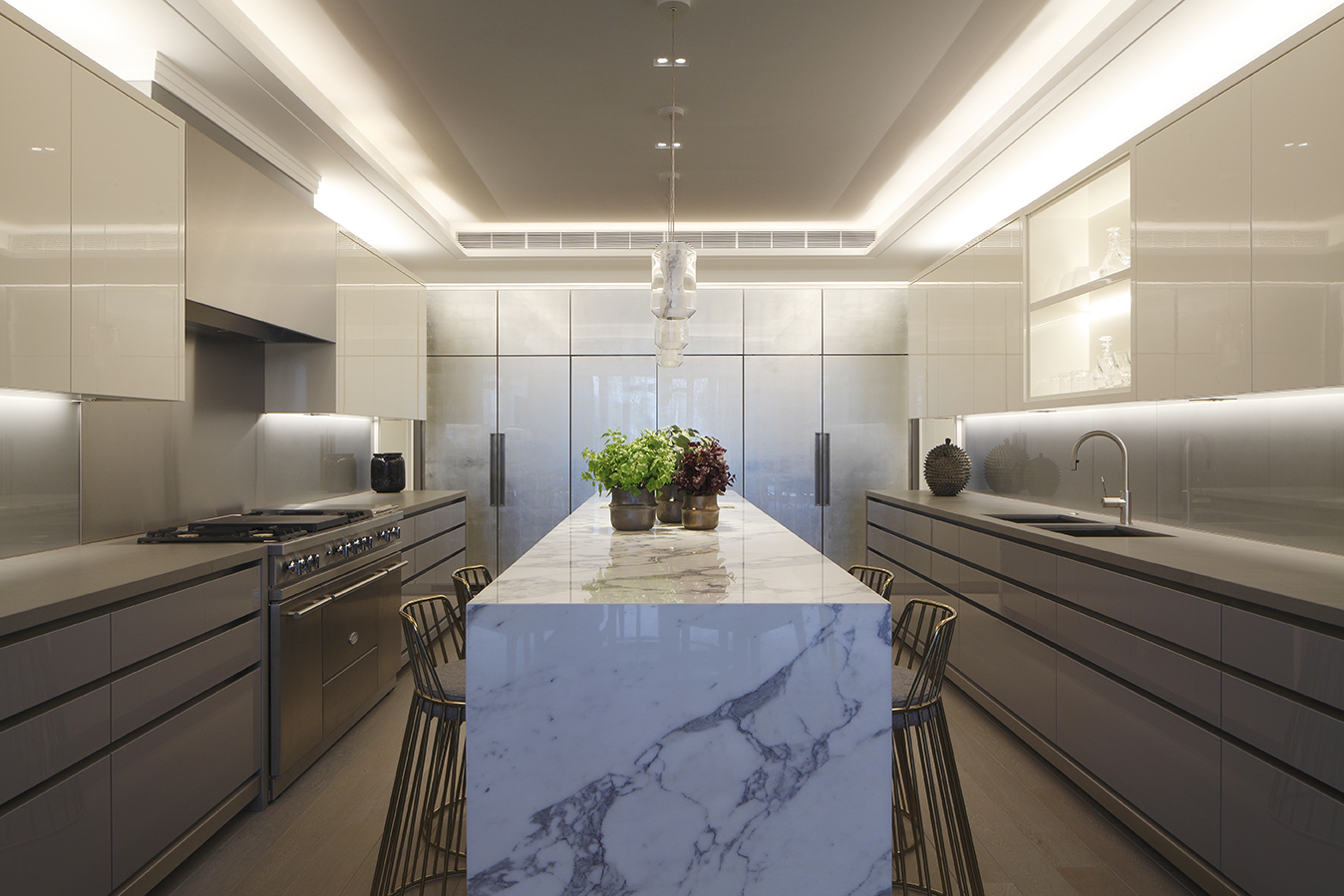 Kitchen ceiling and cabinet lighting in a modern grey kitchen with marble surfaces.
