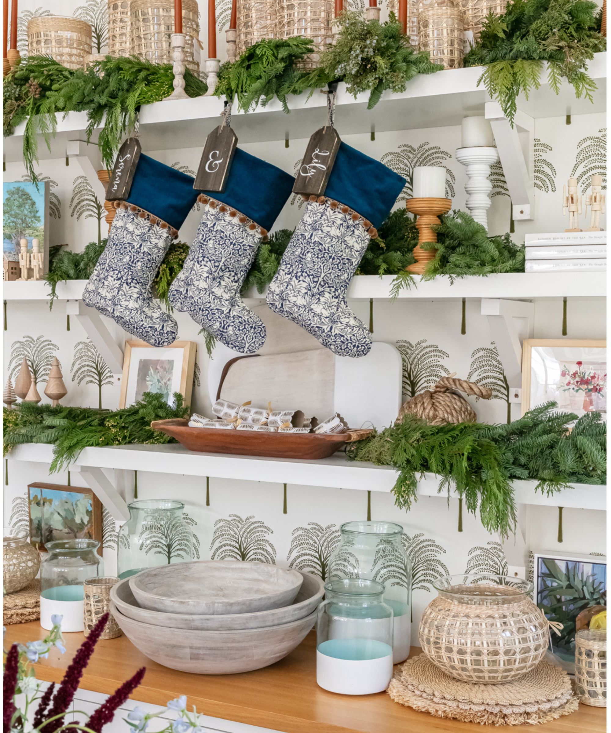 Kitchen dresser decorated with Chtistmas stockings, candles and greenery