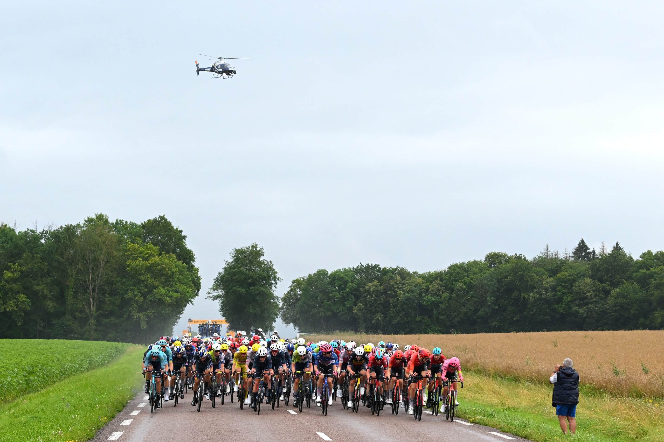 A TV helicopter follows the Tour de France peloton