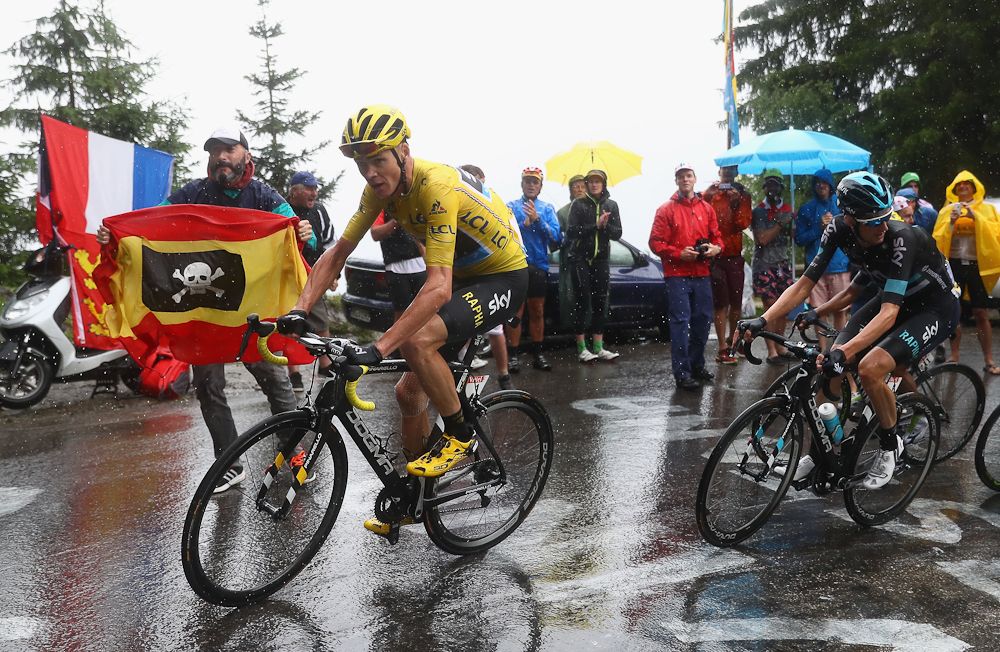 Chris Froome rides in the rain during stage 20 at the Tour de France.