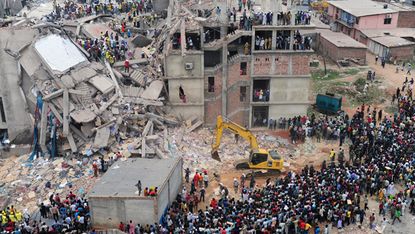 Bangladeshi volunteers and rescue workers are pictured at the scene after an eight-storey building collapsed in Savar, on the outskirts of Dhaka, on April 25, 2013. Survivors cried out to res