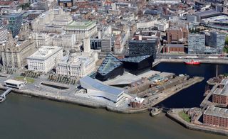 An aerial image of the surrounding waterside site showing building and water