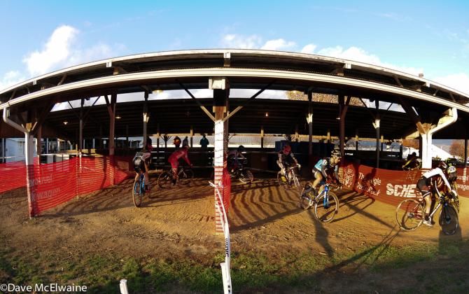 Riders pass through the cow barns