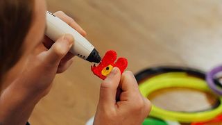 The best 3D pens; a person makes. a model using plastic filament