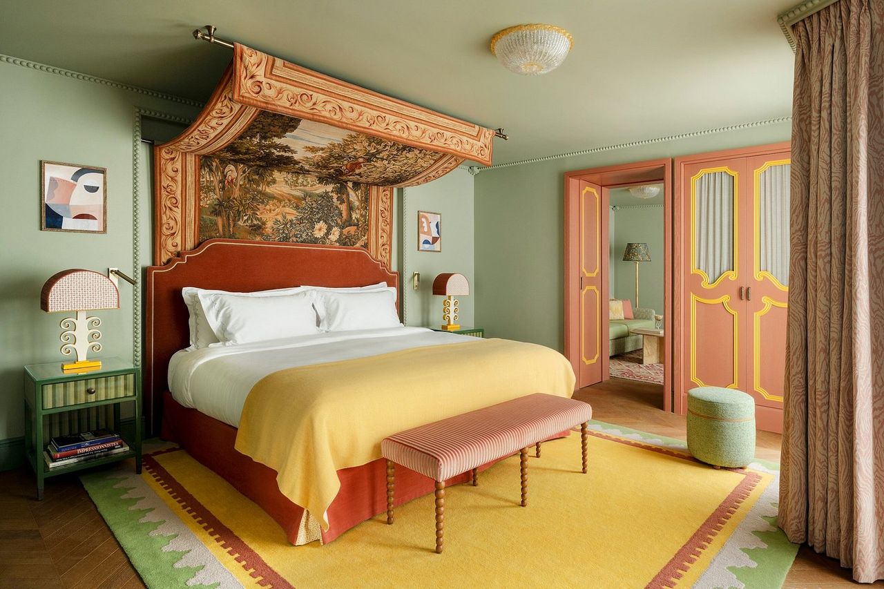 A maximalist Parisian stay features vibrantly decorated rooms filled with tapestries, sculptural artworks and lighting, and a pastel-hued color scheme.