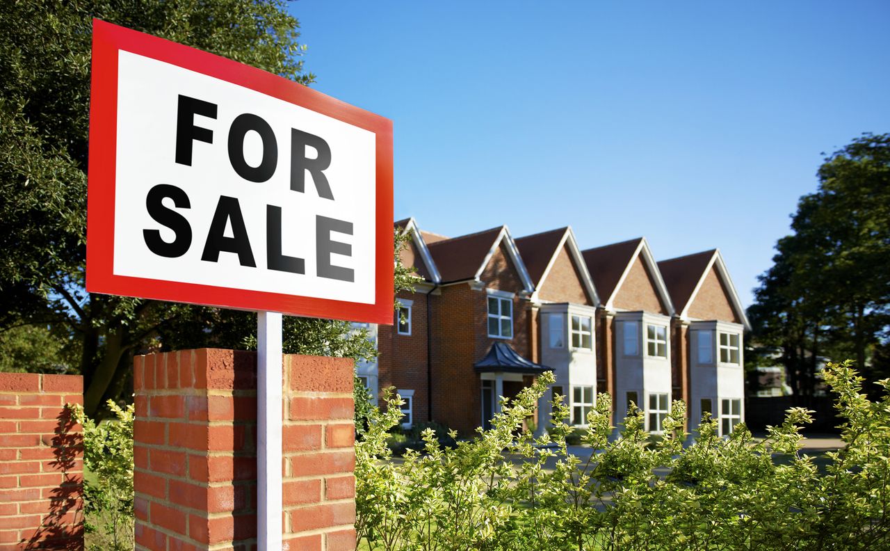 For sale sign outside houses