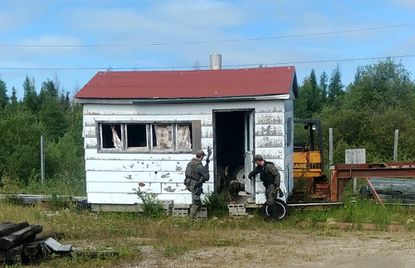 Mounties search a cabin in Manitoba while searching for two murder suspects.