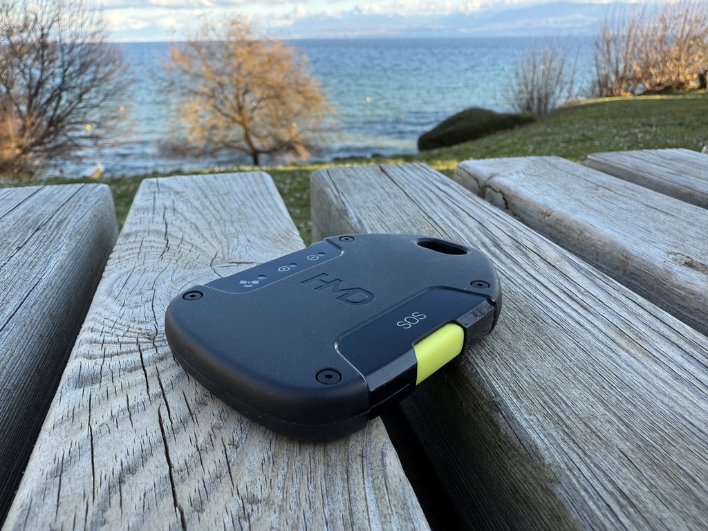 Photo of the HMD OffGrid satellite tool sitting on a deck with a sea in the background