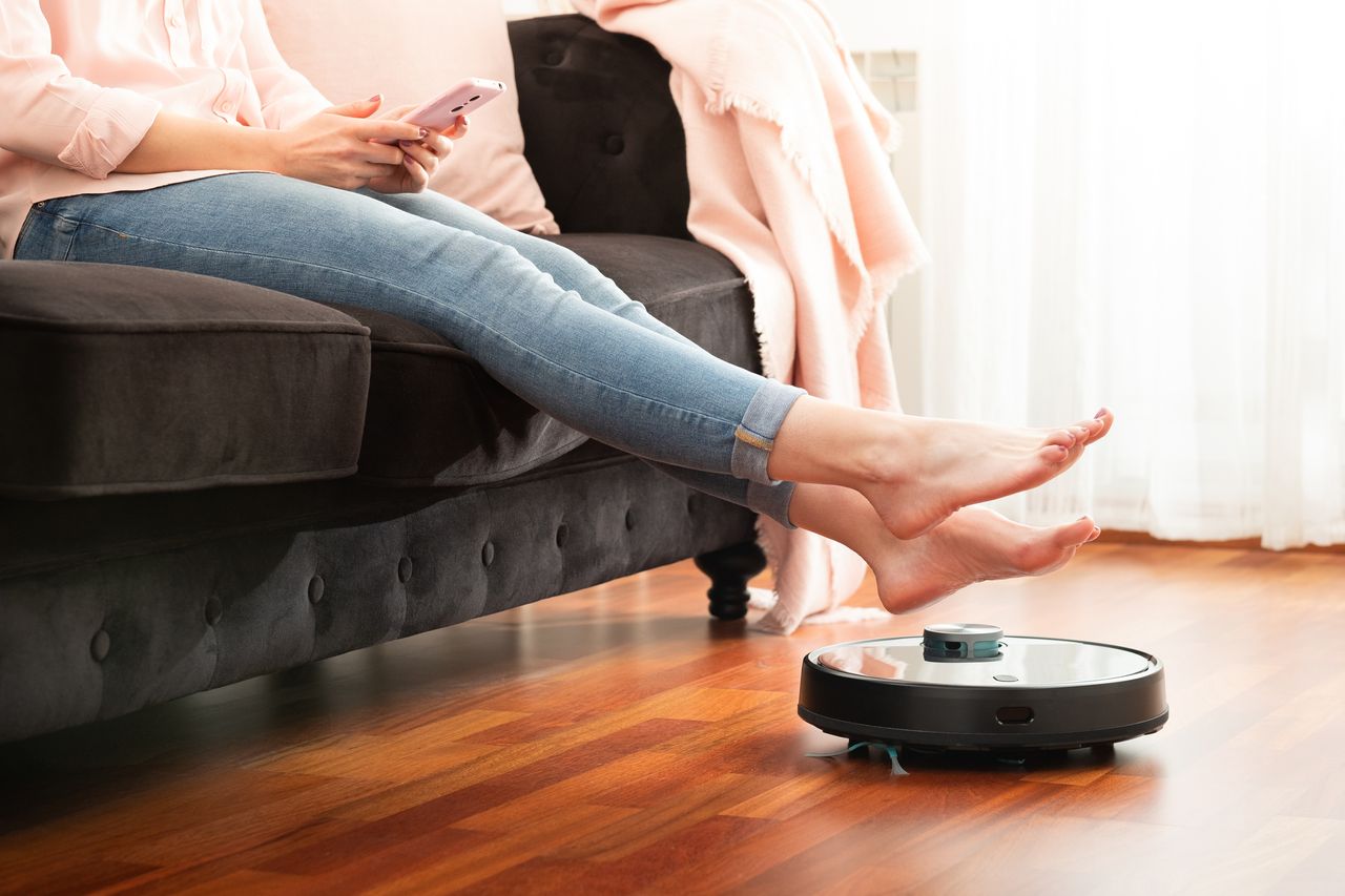 Walmart vacuum Robot vacuum next to couch