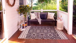 best outdoor rug monochrome reversible design on veranda porch with rattan sofa