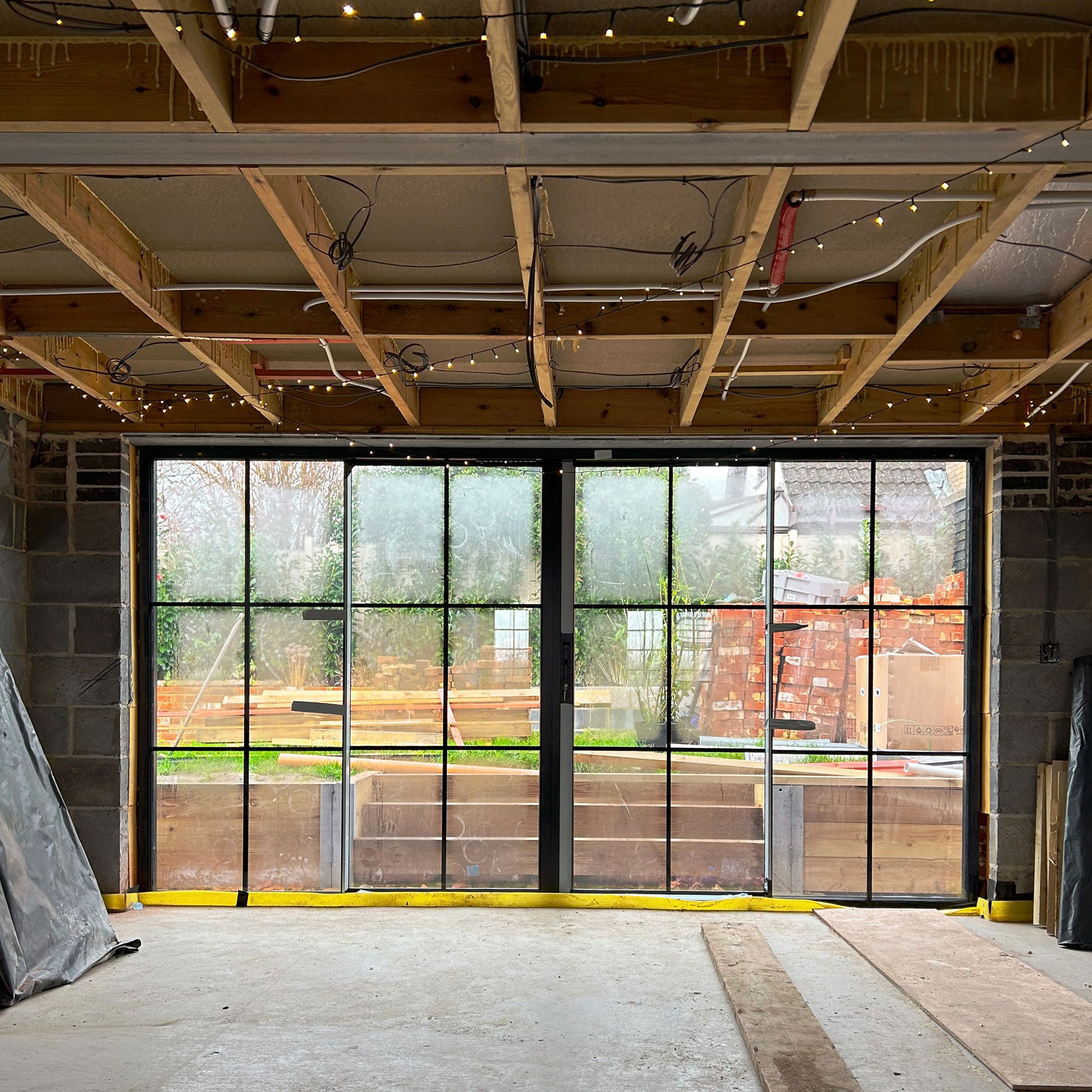 Room with floor to ceiling windows in construction phase