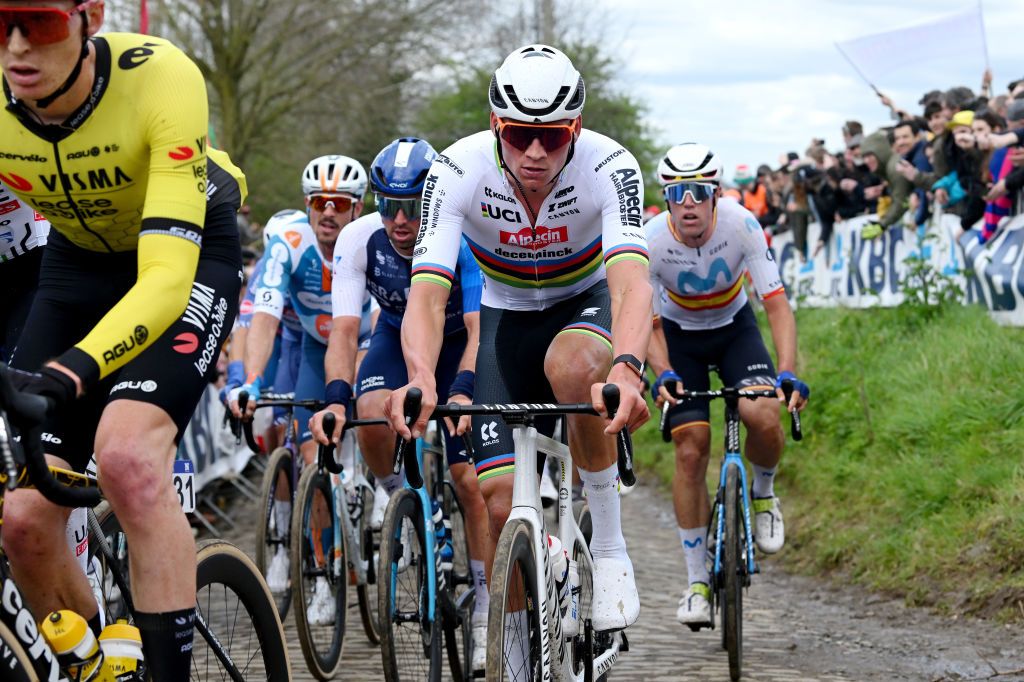 OUDENAARDE BELGIUM MARCH 31 Mathieu van der Poel of The Netherlands and Team Alpecin Deceuninck competes passing through the Oude Kwaremont cobblestones sector while fans cheer during the 108th Ronde van Vlaanderen Tour des Flandres 2024 Mens Elite a 2708km one day race from Antwerpen to Oudenaarde UCIWT on March 31 2024 in Oudenaarde Belgium Photo by Dario BelingheriGetty Images