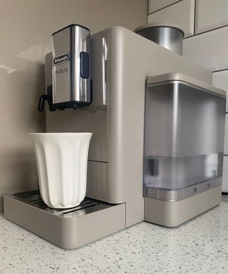 De'Longhi Rivelia fully-automatic bean-to-cup coffee maker in Sand Beige in Christina Chrysostomou's kitchen with white porcelain coffee cup