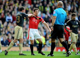 Jamie Carragher (L) of Liverpool argues with Gary Neville of Manchester United after United were awarded a penalty in the first half of the Barclays Premier League match between Manchester United and Liverpool at Old Trafford on March 21, 2010 in Manchester, England.
