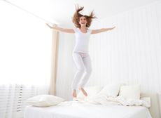 Lady jumping on a mattress