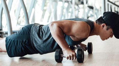 Man doing home workout with dumbbells