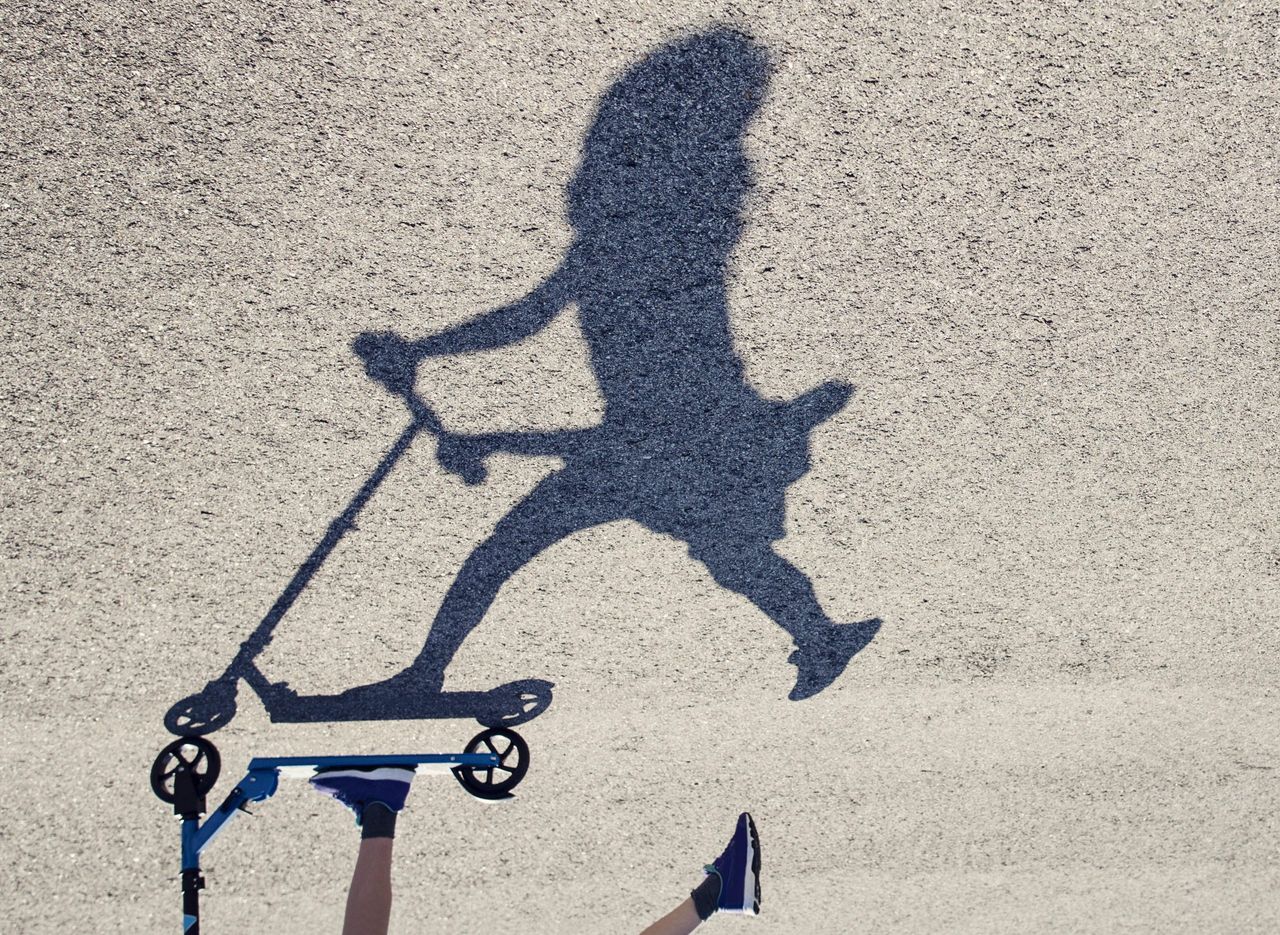 Girl riding her push scooter