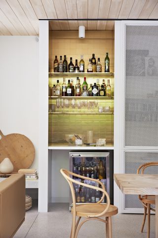 Home bar in a kitchen with yellow tiles walls