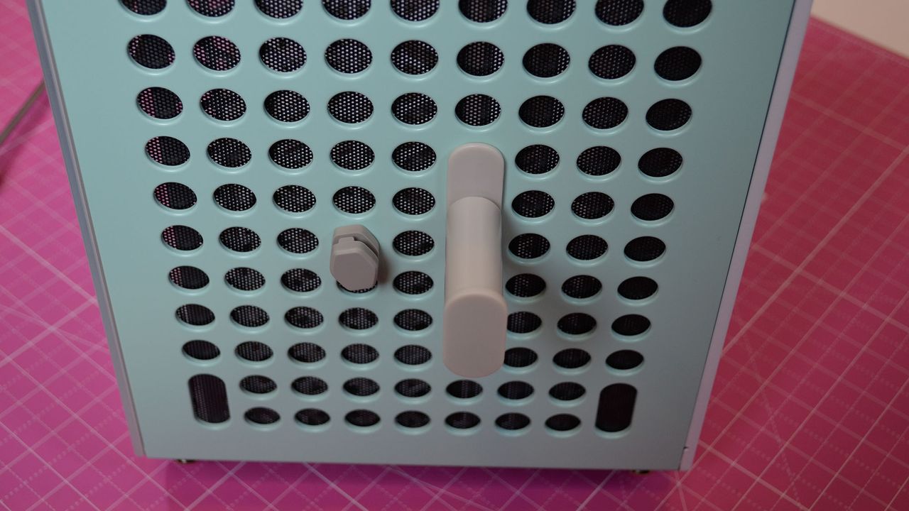Attachments for the Cooler Master Qube 500 PC case inserted into its front panel