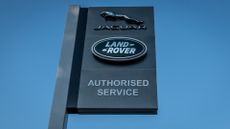 Jaguar Land Rover dealership sign in Taunton, Somerset, featuring Jaguar logo and Land Rover logo.