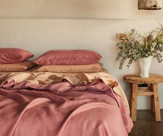 Bed Threads sheets in pink clay, rust, and terracotta.