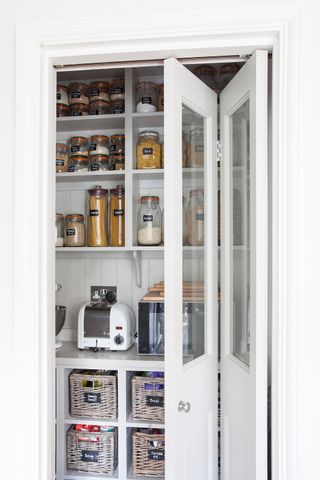 Pantry with goods stored in glass jars and baskets