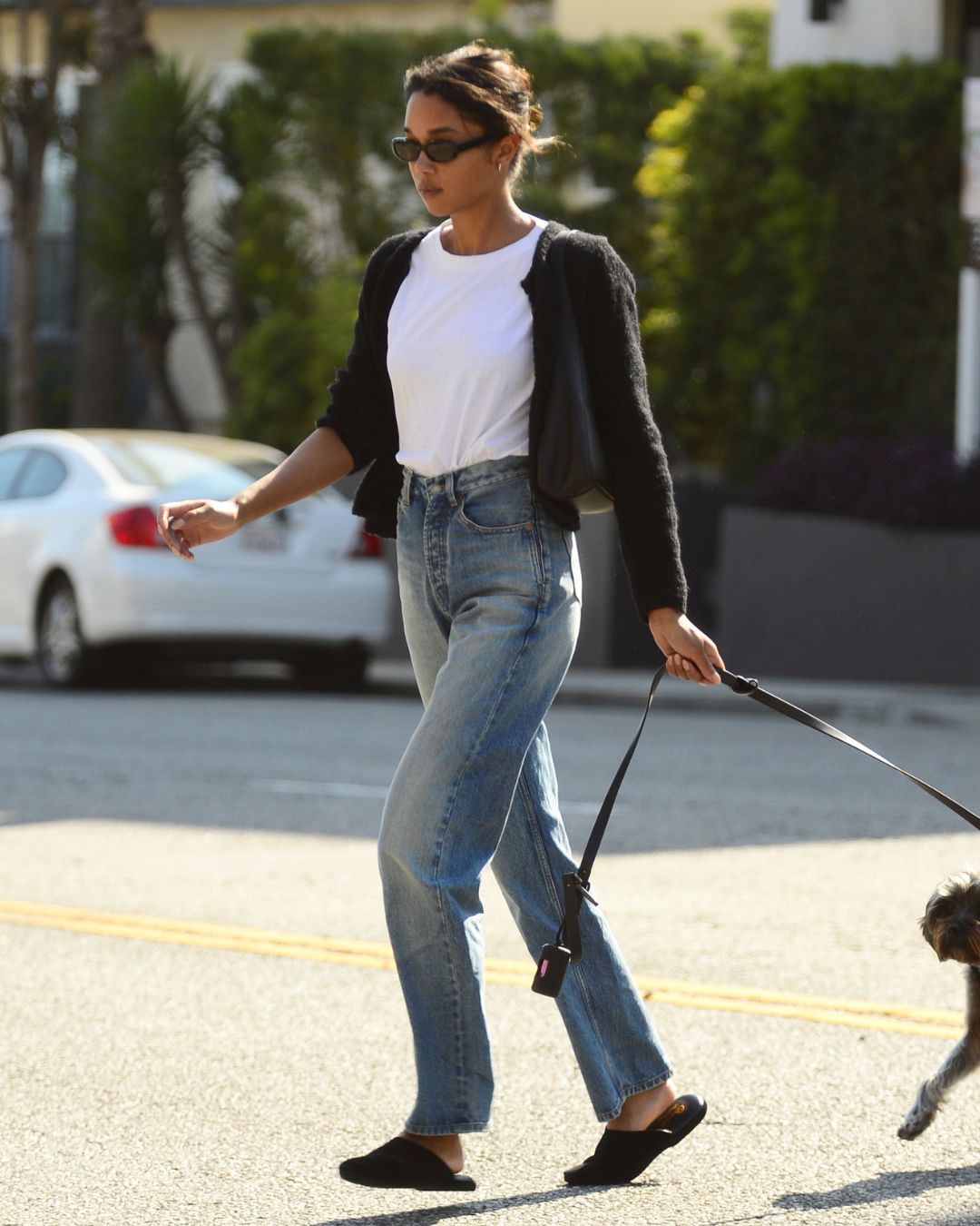 Laura Harrier styles flat mules.