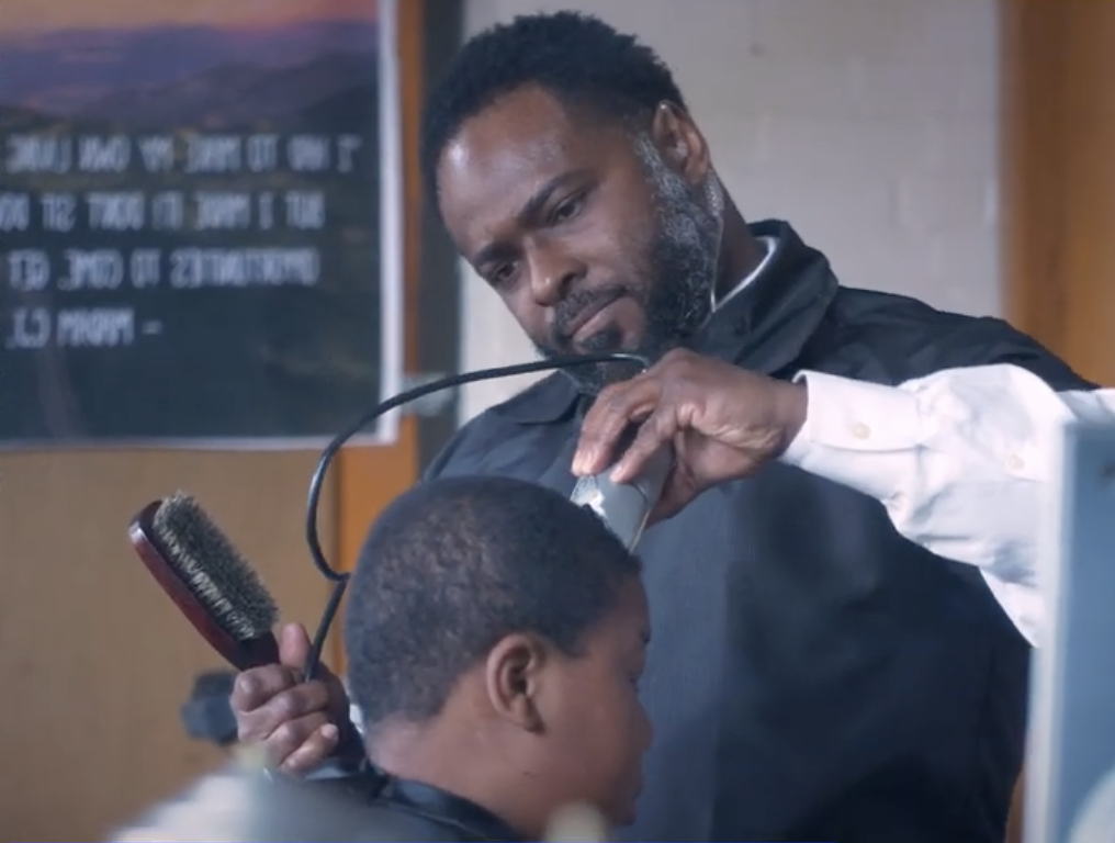 Terrance Newton cuts a student&amp;#039;s hair.