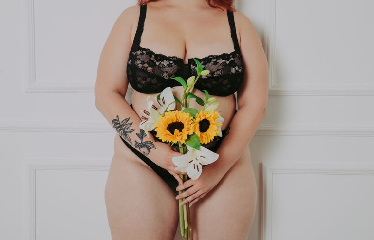 Body acceptance concept. curvy girl posing in studio against society prejudice