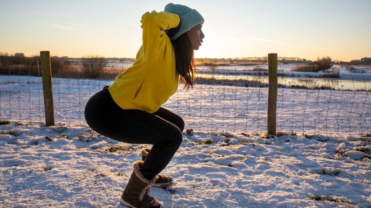 Woman performs prisoner squat