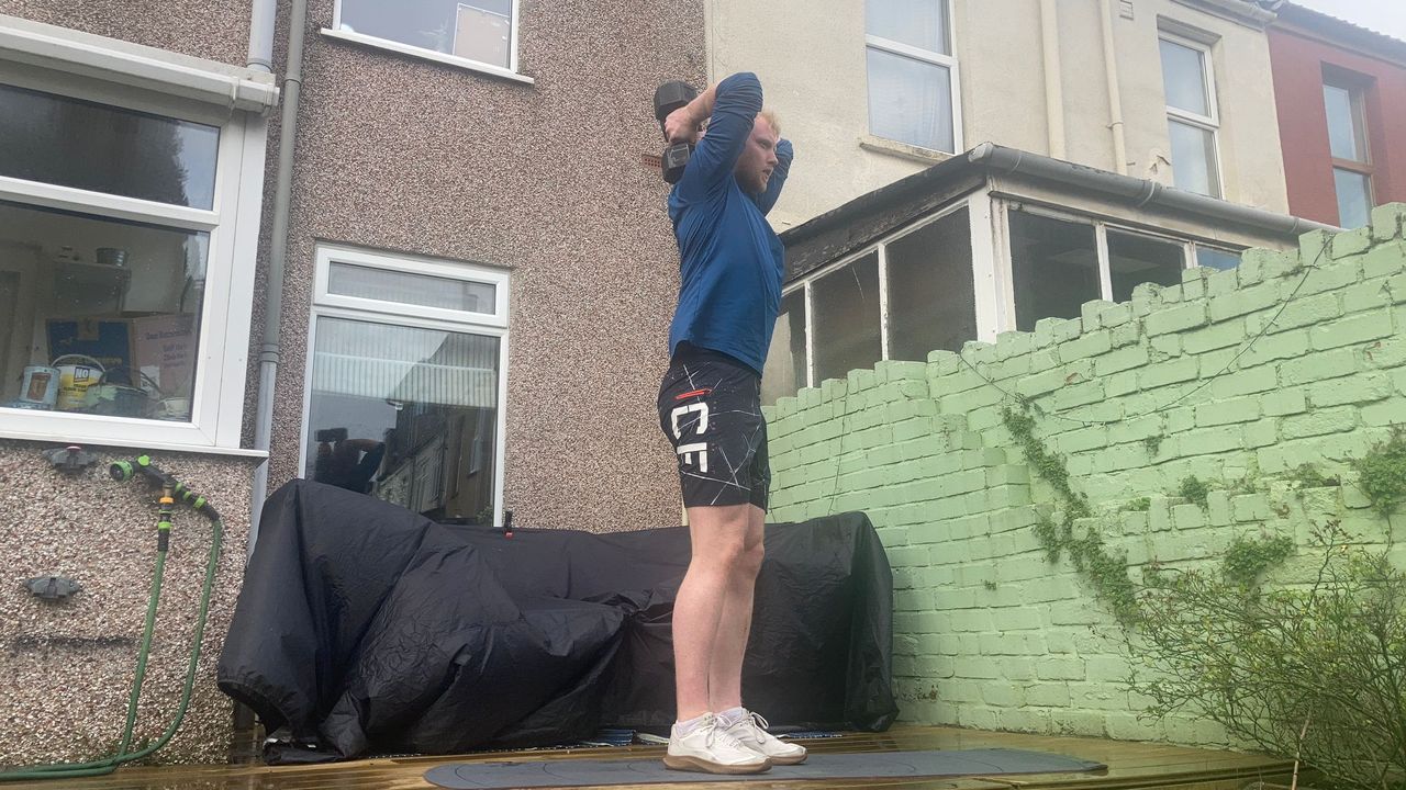 Fit&amp;Well fitness writer Harry Bullmore demonstrating an overhead triceps extension