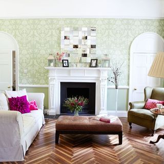 Living room with green wallpaper and brown parquet floor