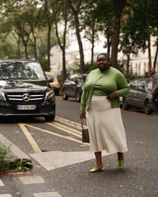 @abimarvel wearing top and cardigan with skirt