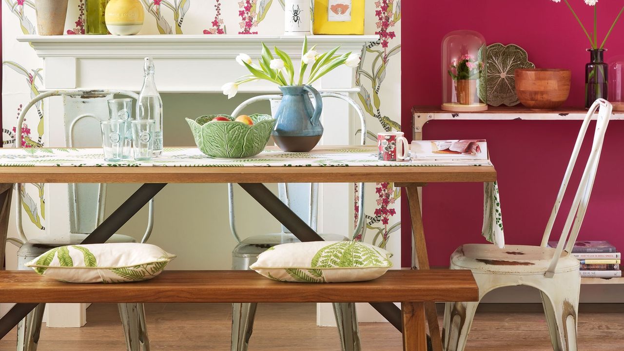 dining area with white wall and wooden table with chair