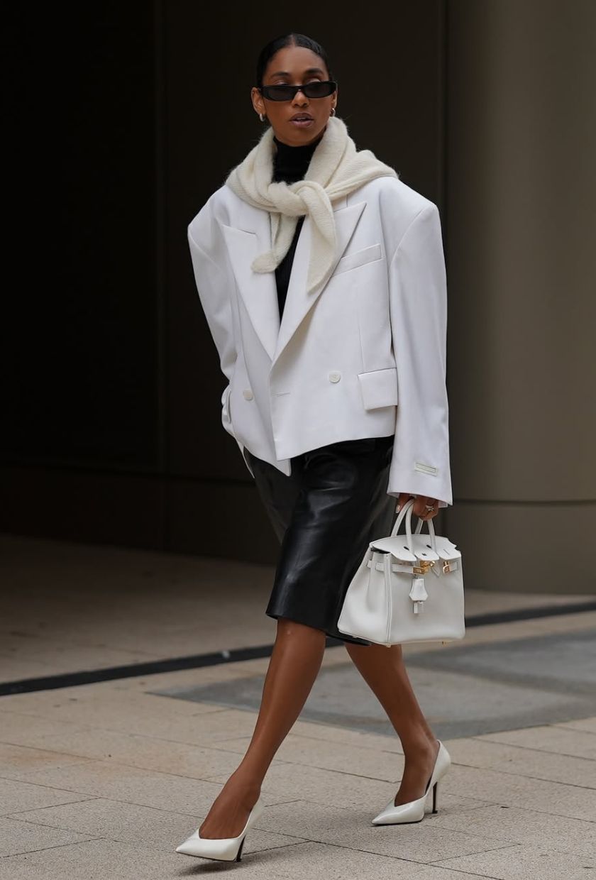 @cherifaakili wears white cropped blazer, leather shorts, white heels, scarf, bag and black sunglasses