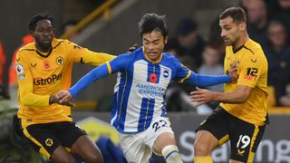 Kaoru Mitoma of Brighton & Hove Albion is put under pressure by Boubacar Traore and Jonny of Wolverhampton Wanderers during a Premier League match between Wolverhampton Wanderers and Brighton & Hove Albion