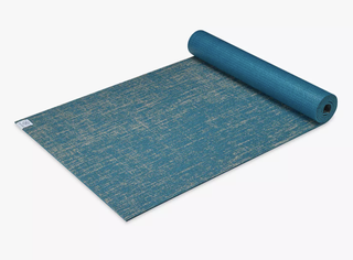 Gaiam 5mm thick yoga mat partially rolled up