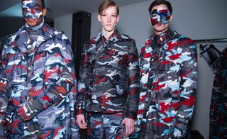Male models in blue, grey, white and red camo outfits