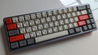 Drop Alt keyboard with retro-styled, Japanese and english keycaps in beige, grey, and red