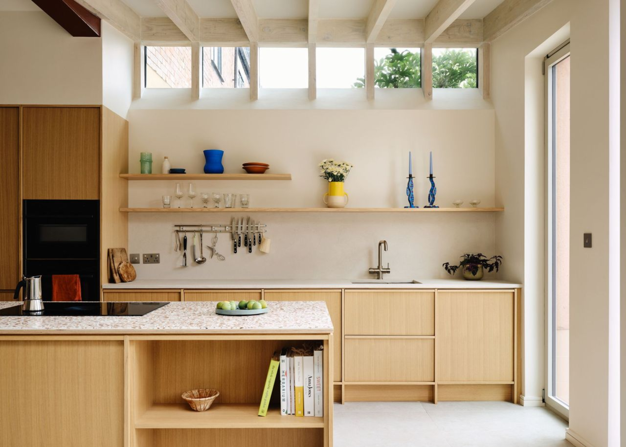 warm, neutral toned kitchen with wooden cabinets and terrazzo counters