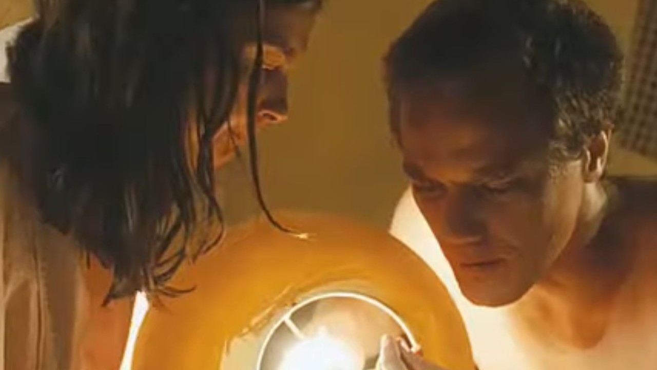 Ashley Judd and Michael Shannon staring at something in a light in Bug