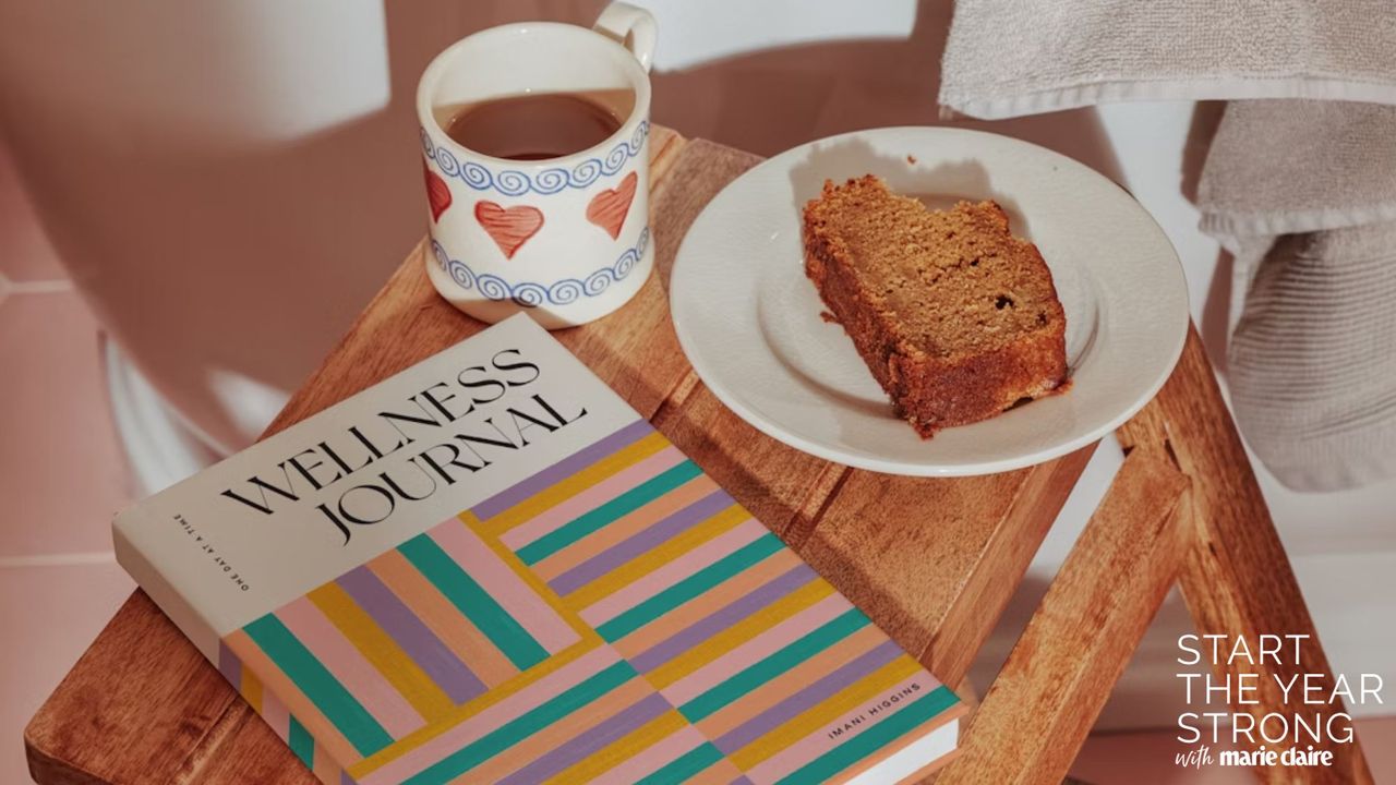 papier wellness journal with cup of tea and slice of cake