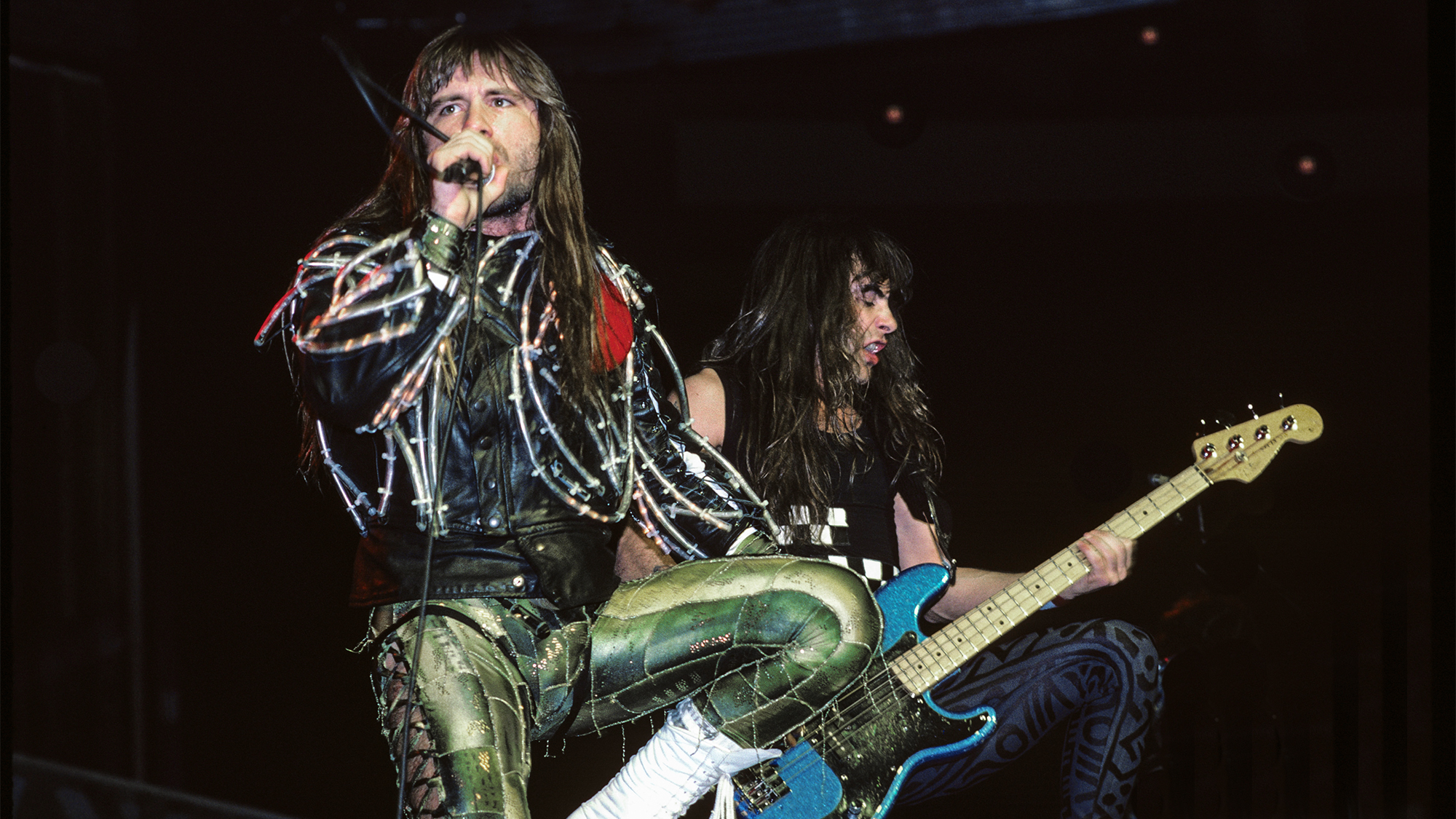 Iron Maiden's Bruce Dickinson and Steve Harris performing live onstage on Somewhere On Tour tour, wearing spandex, April 2, 1987
