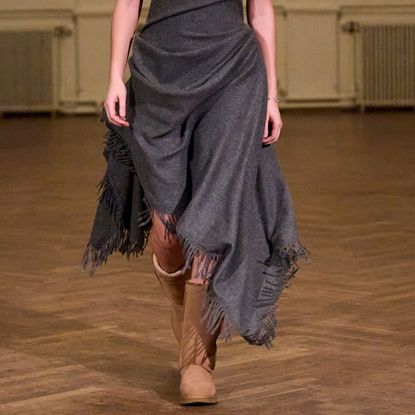 a model wearing uggs on the runway at anne sofie madsen